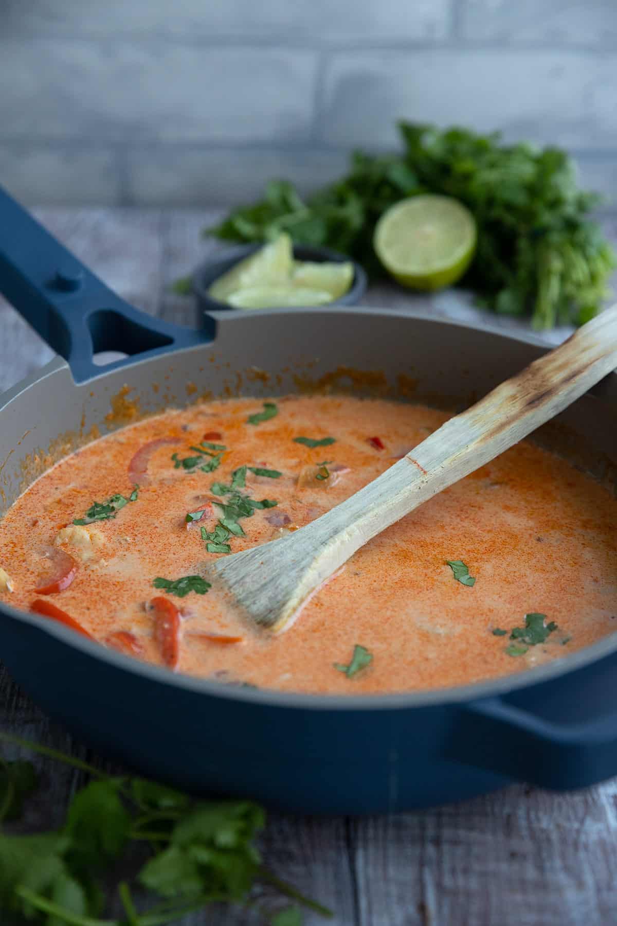 A blue pan filled with Moqueca, a Brazilian Fish Stew.