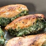 Titled image of Spinach Stuffed Chicken Breasts in a skillet.