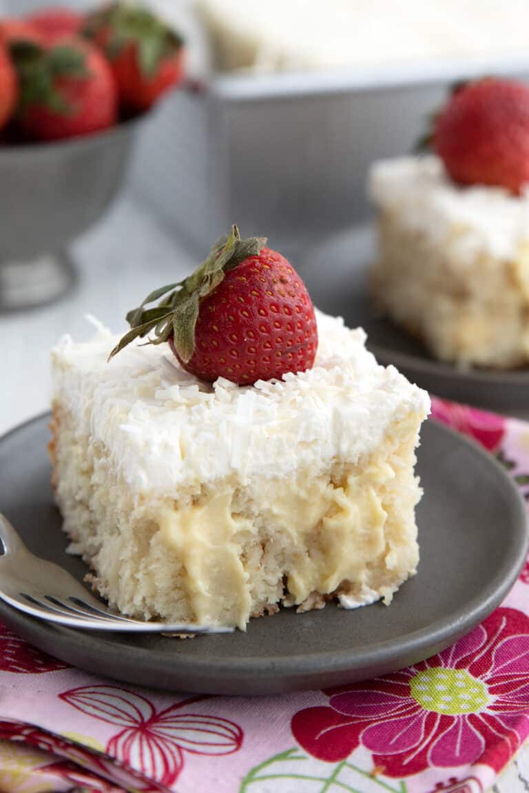 Close up shot of a slice of Keto Coconut Cream Poke Cake.