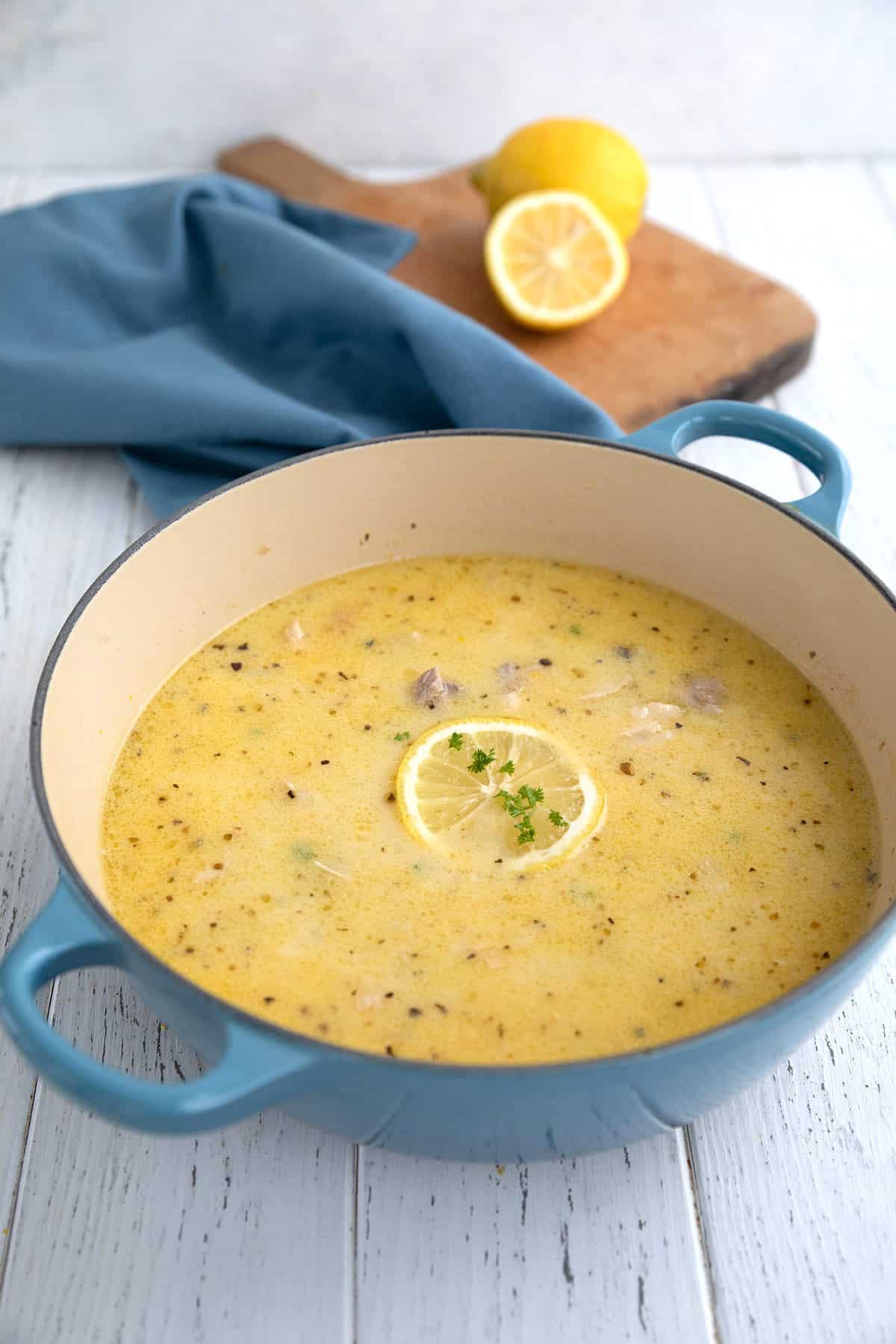 A blue dutch oven filled with Keto Lemon Chicken Soup.