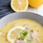 Titled image for Keto Lemon Chicken Soup in a gray bowl with a lemon slice on top.