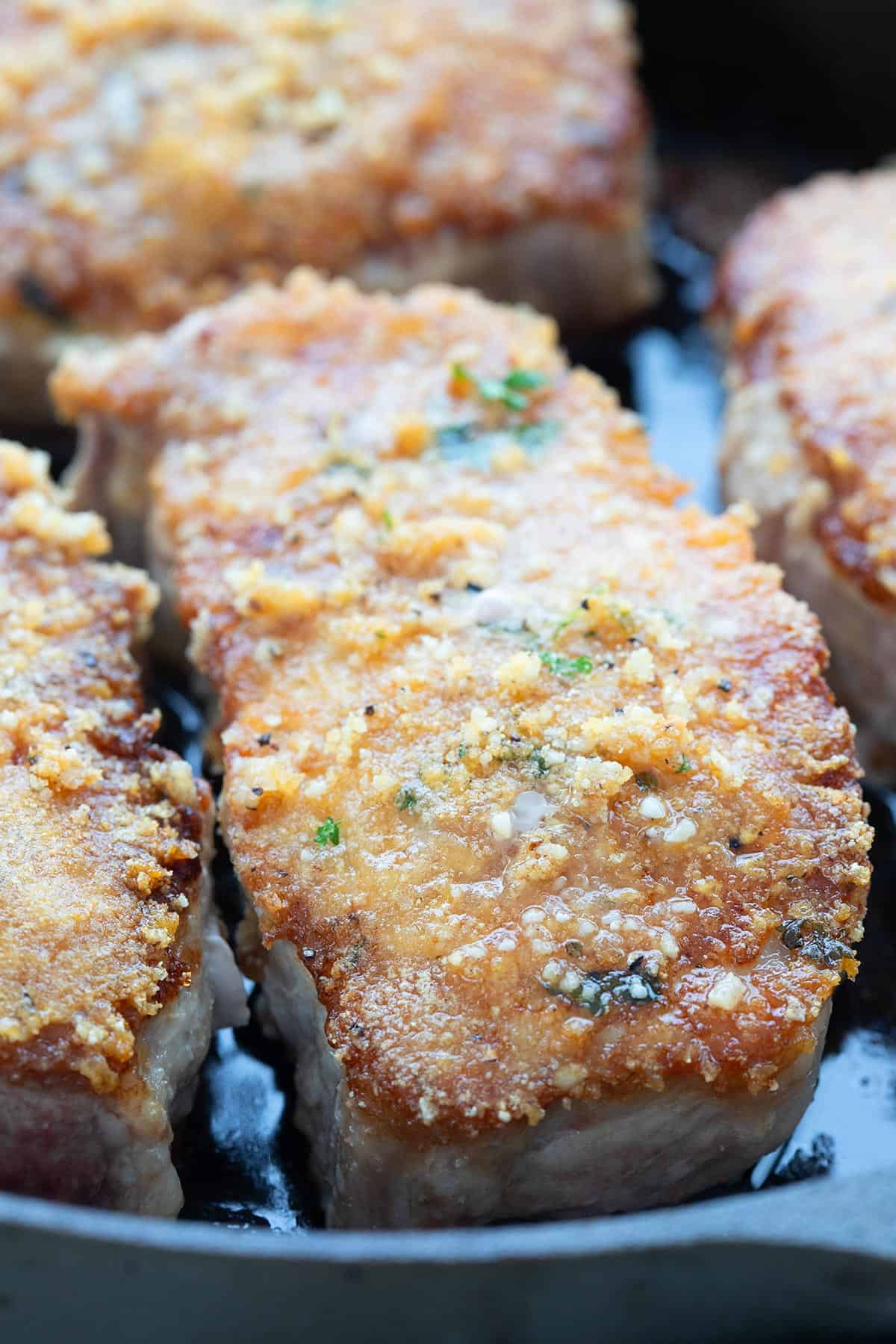 Close up shot of Parmesan Crusted Pork Chops in the pan.