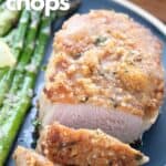 Titled image of a Keto Parmesan Crusted Pork Chop sliced on a blue plate with asparagus.