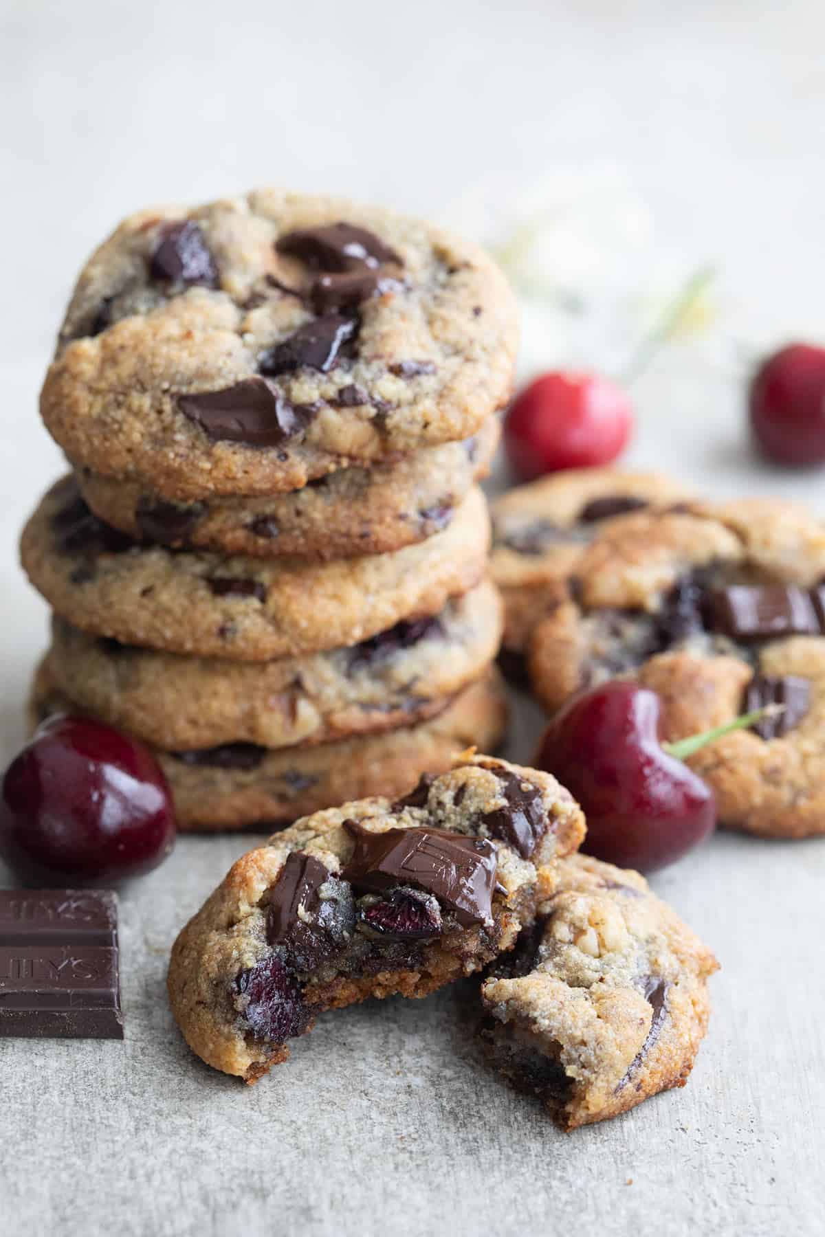 A Cherry Chocolate Chunk Cookie broken open to show the inside.