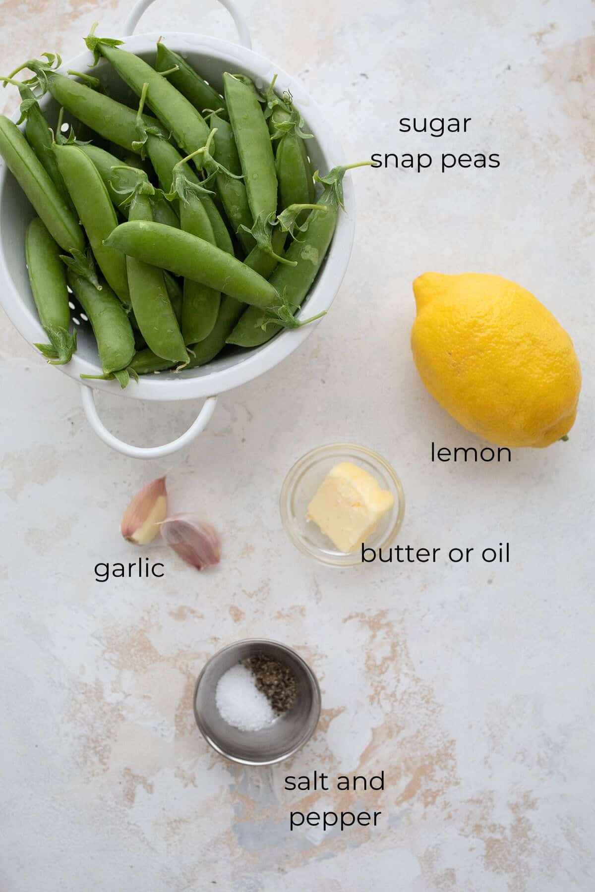 Top down image of ingredients needed for lemon garlic sugar snap peas.