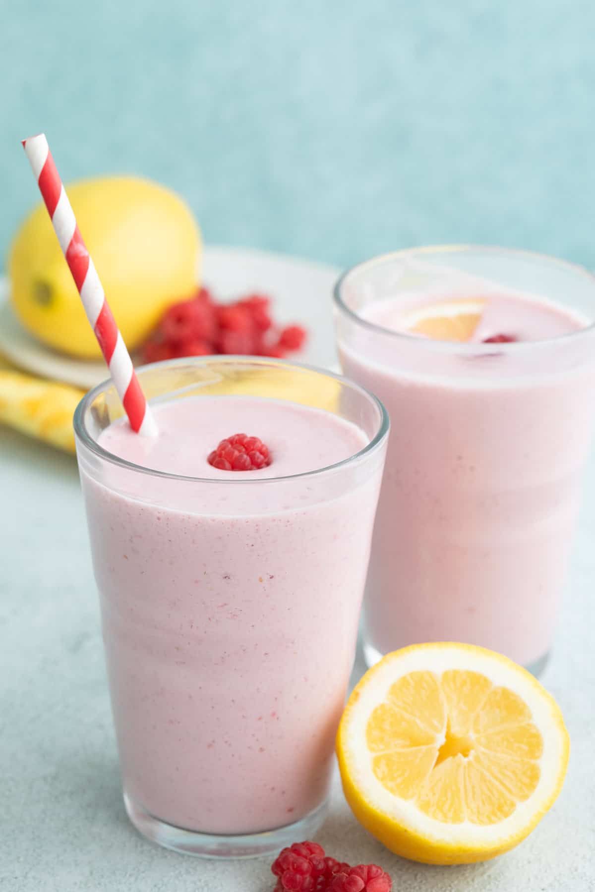 Two raspberry lemonade keto smoothies in glasses on a concrete table.