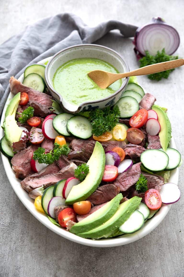 Chimichurri Steak Salad arranged on a large oval platter.