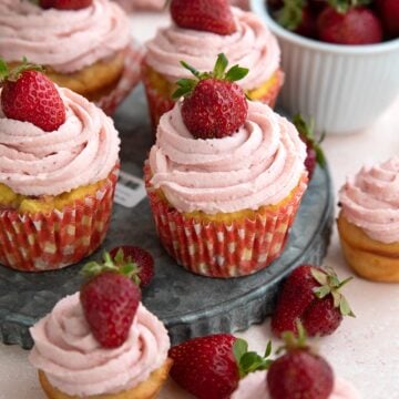 Keto Strawberry Cupcakes on a pink table.