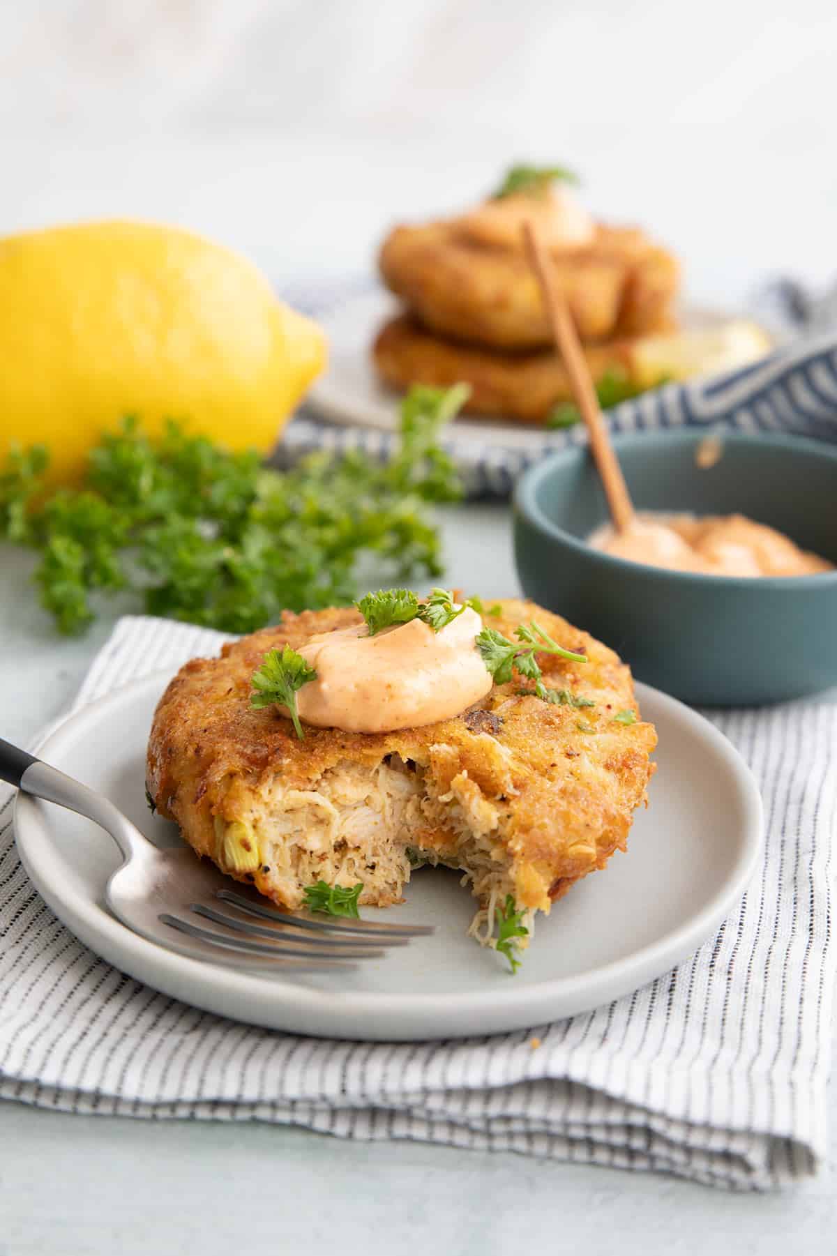 An air fryer crab cake with a forkful taken out of it.