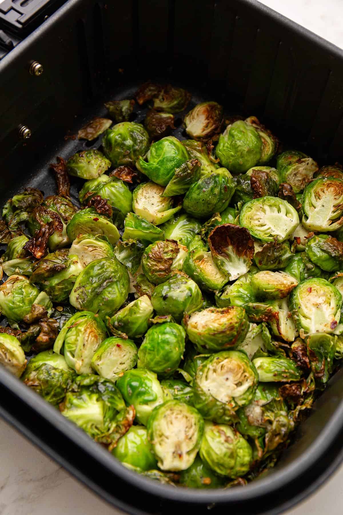 Air Fryer Brussels sprouts in the air fryer basket.