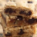 Close up titled image of a stack of keto chocolate chip blondies.