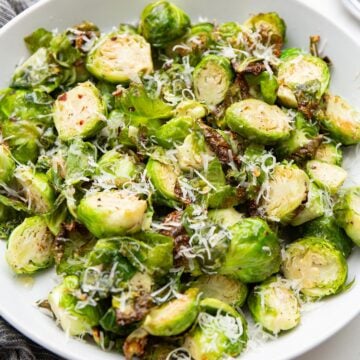 Air Fryer Brussels sprouts in a white serving bowl.