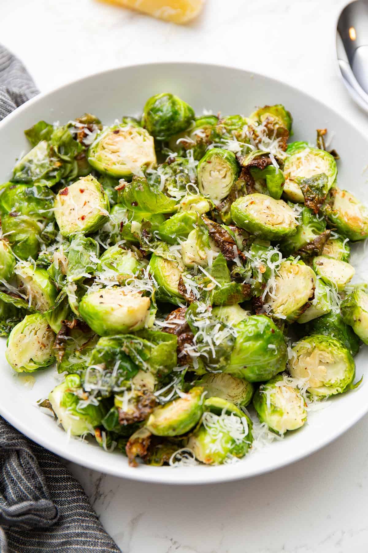 Air Fryer Brussels sprouts in a white serving bowl.