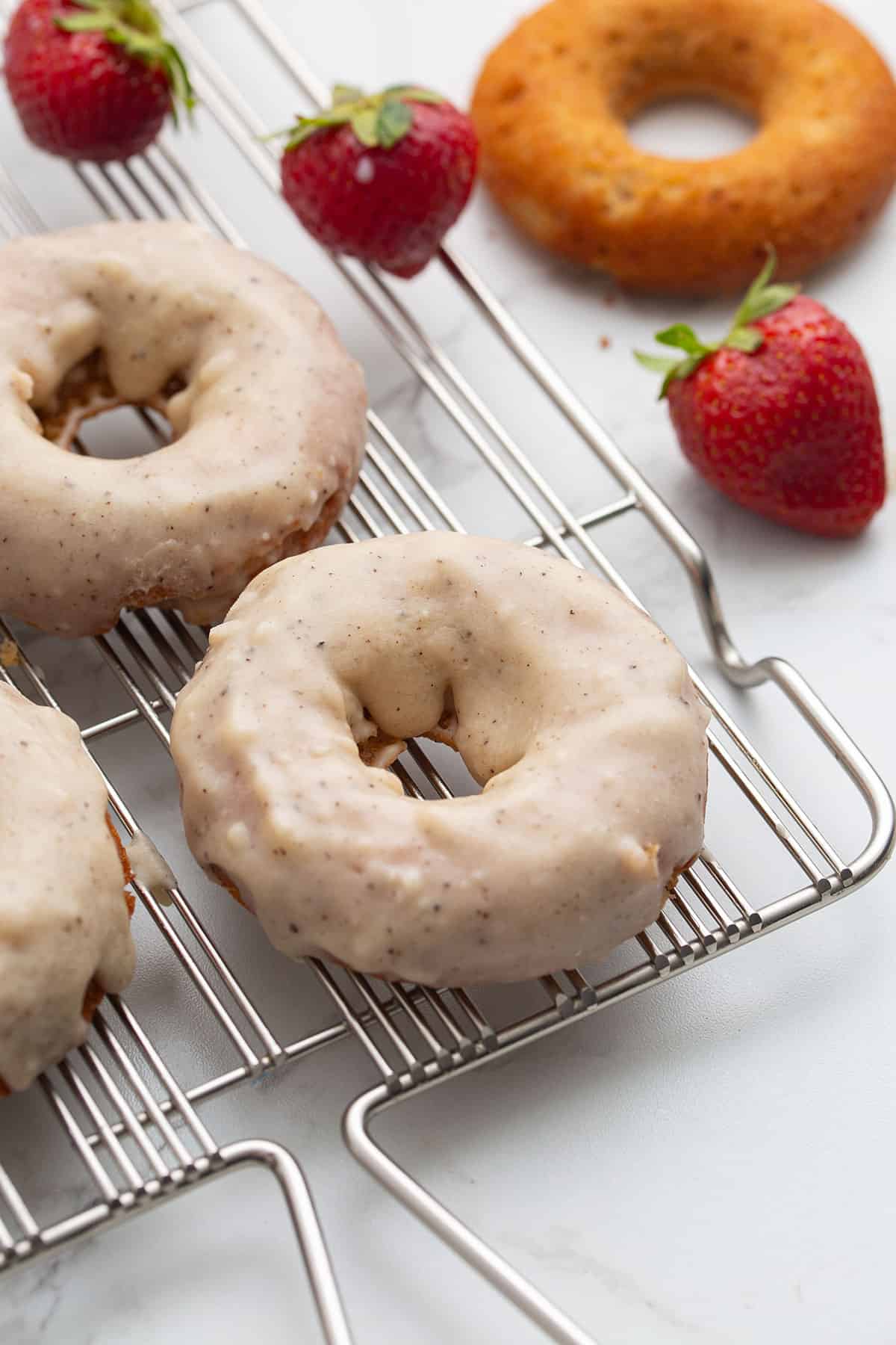Keto donuts with brown butter glaze on a cooling rack.