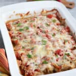 Salsa Fresca Chicken Casserole in a white baking dish on a concrete table.