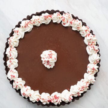 Top down image of Keto Chocolate Peppermint Tart on a marble tabletop.
