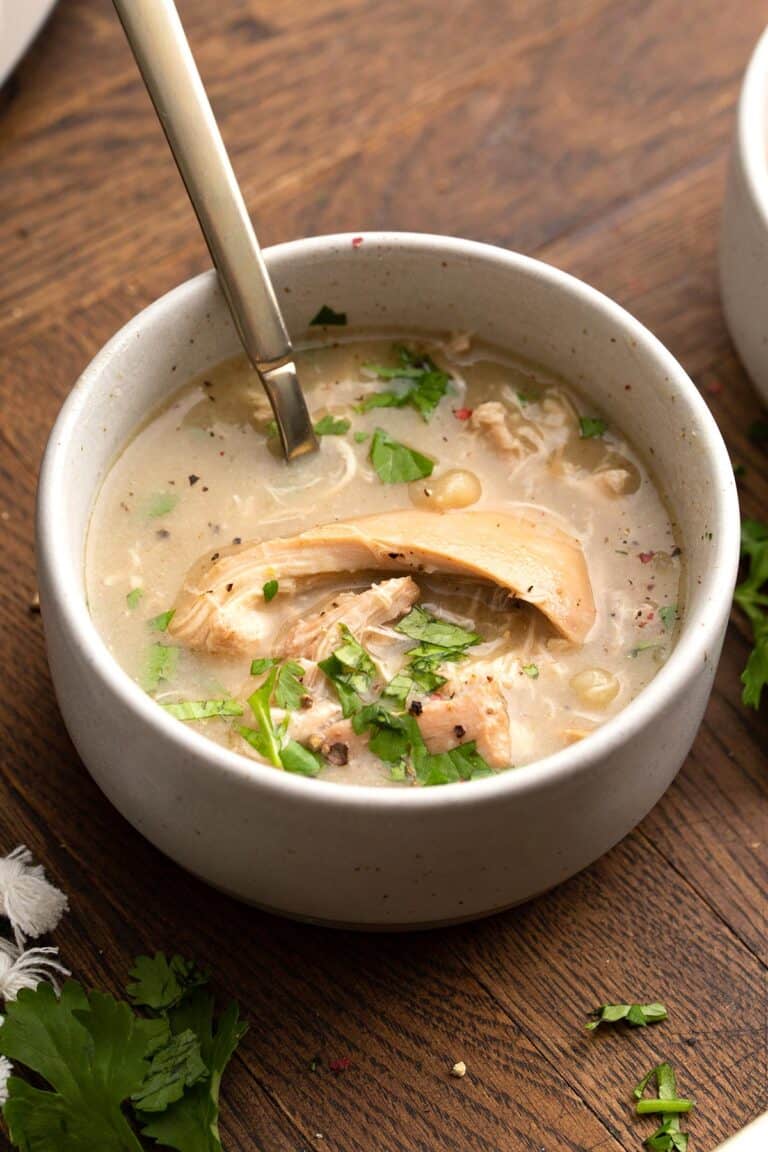 Keto White Chicken Chili in a white bowl with a spoon in it.