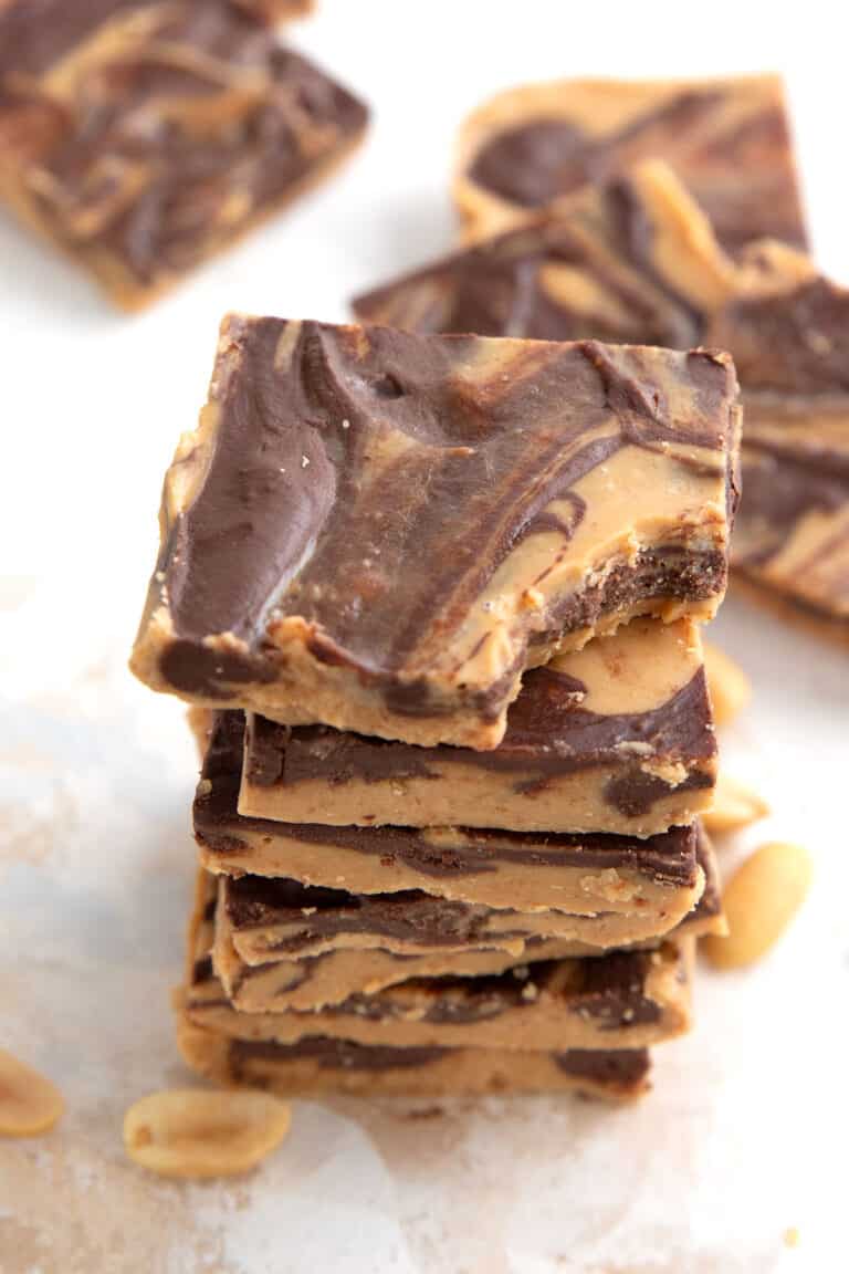 A stack of keto tiger butter squares on a marble table.