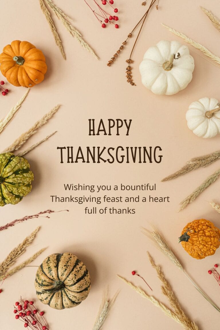 Top down image of pumpkins and dried grasses with Happy Thanksgiving in the center.