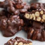 Titled image of keto peanut clusters in a pile with one cut open.