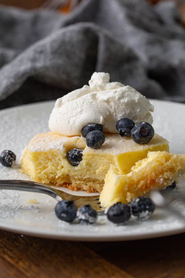 Close up shot of a piece of Gooey Keto Butter Cake with a forkful taken out of it.