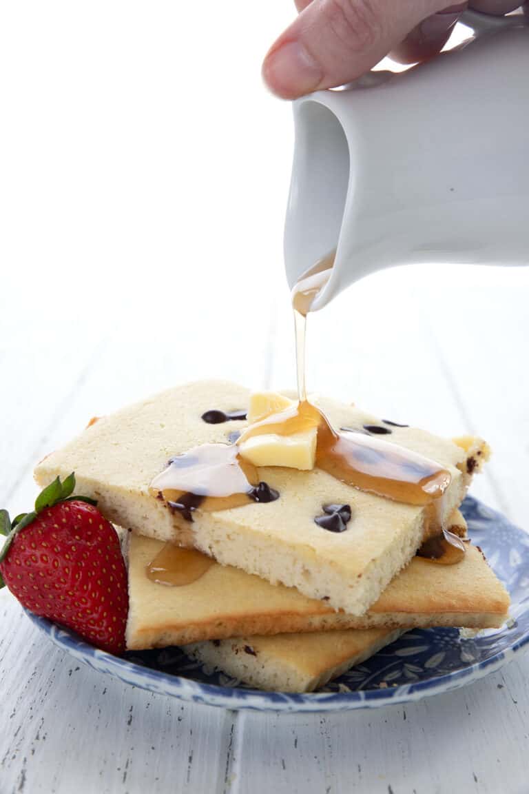 Sugar Free Maple Syrup being drizzled over Keto Sheet Pan Pancakes.