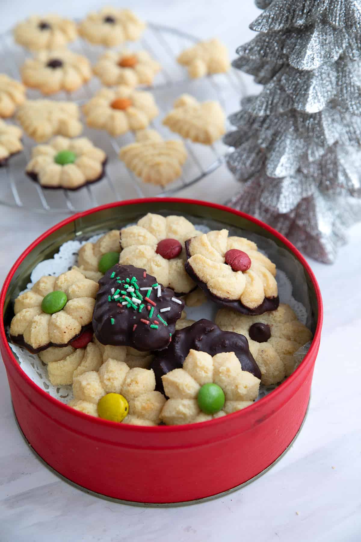 Keto Spritz Cookies in a red Christmas tin.