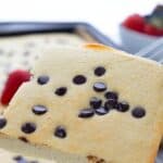 Titled image of a slice of sheet pan keto pancakes being lifted from the rest of the sheet pan.