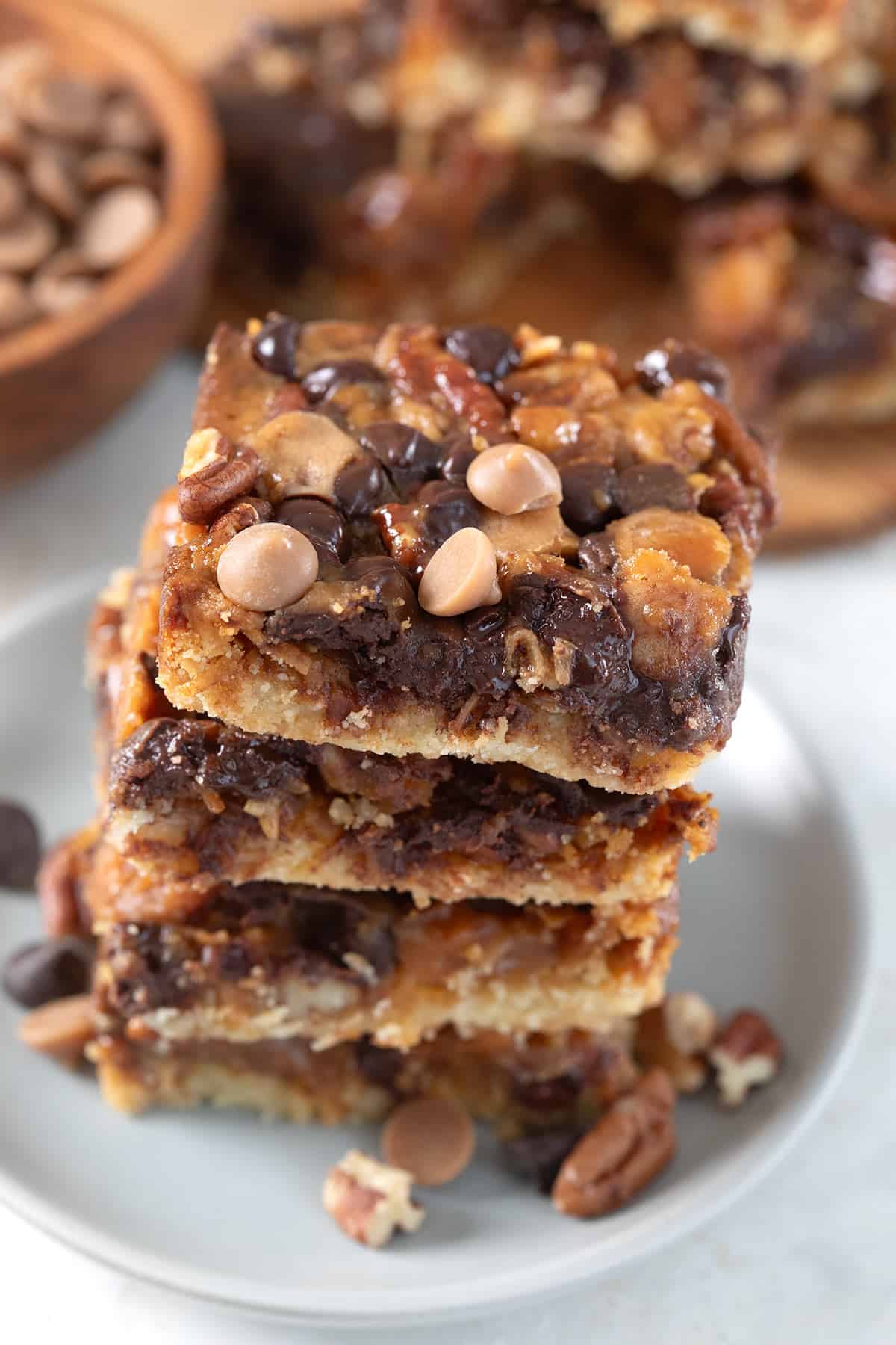 Keto Salted Caramel Magic Bars in a stack on a small gray plate.