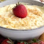 Titled Pinterest image of Keto Coconut Cream Dip in a gray bowl, surrounded by strawberries.