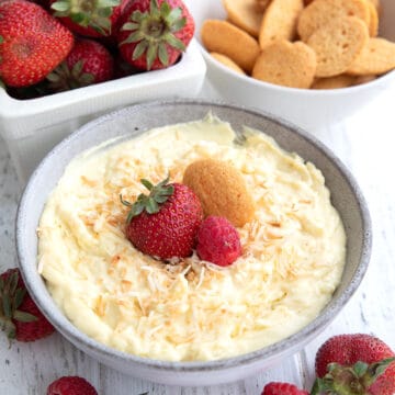 Coconut Cream Pie Dip in a gray bowl on a white wooden table.