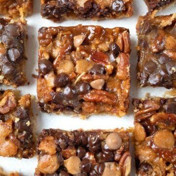 Top down image of Keto Salted Caramel Magic Cookie Bars on a white table.