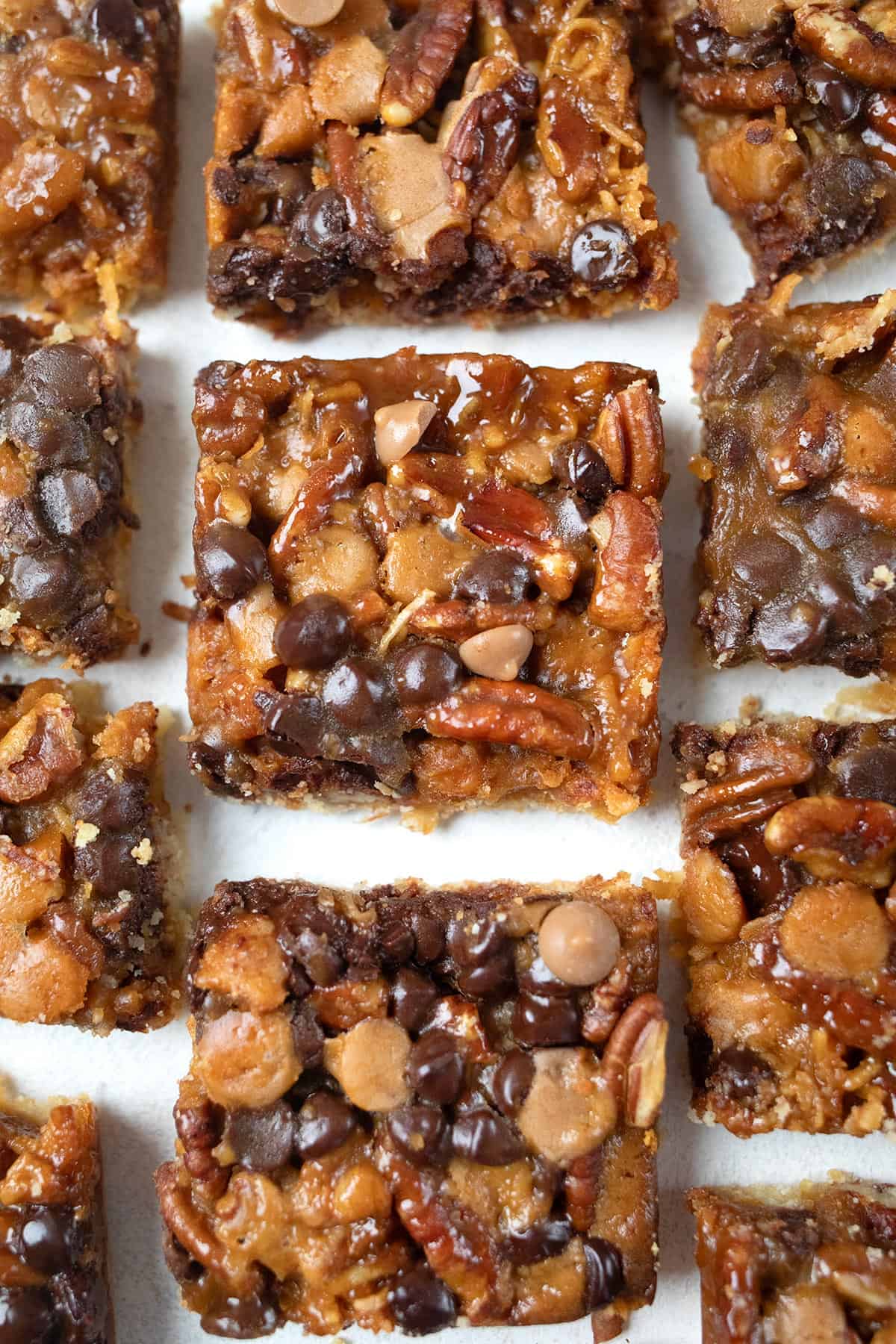 Top down image of Keto Salted Caramel Magic Cookie Bars on a white table.