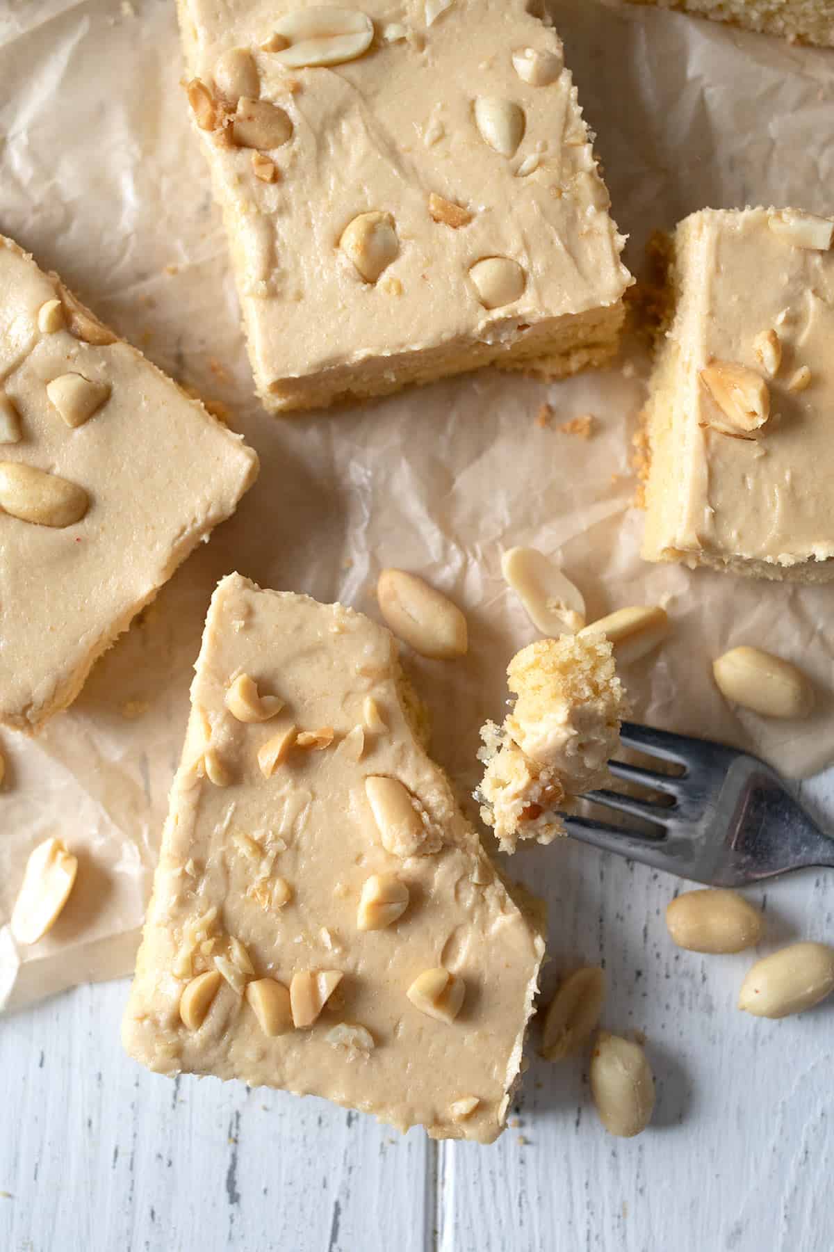 Top down image of pieces of Keto Peanut Butter Sheet Cake on crinkled brown paper.