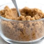 Titled image of a glass bowl filled with keto brown sugar substitute.