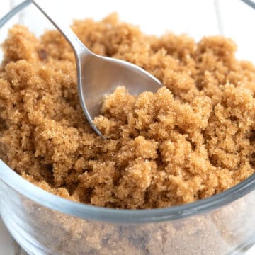 Close up shot of keto brown sugar alternative in a glass dish with a spoon in it.