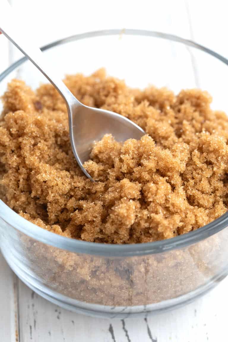 Close up shot of keto brown sugar alternative in a glass dish with a spoon in it.