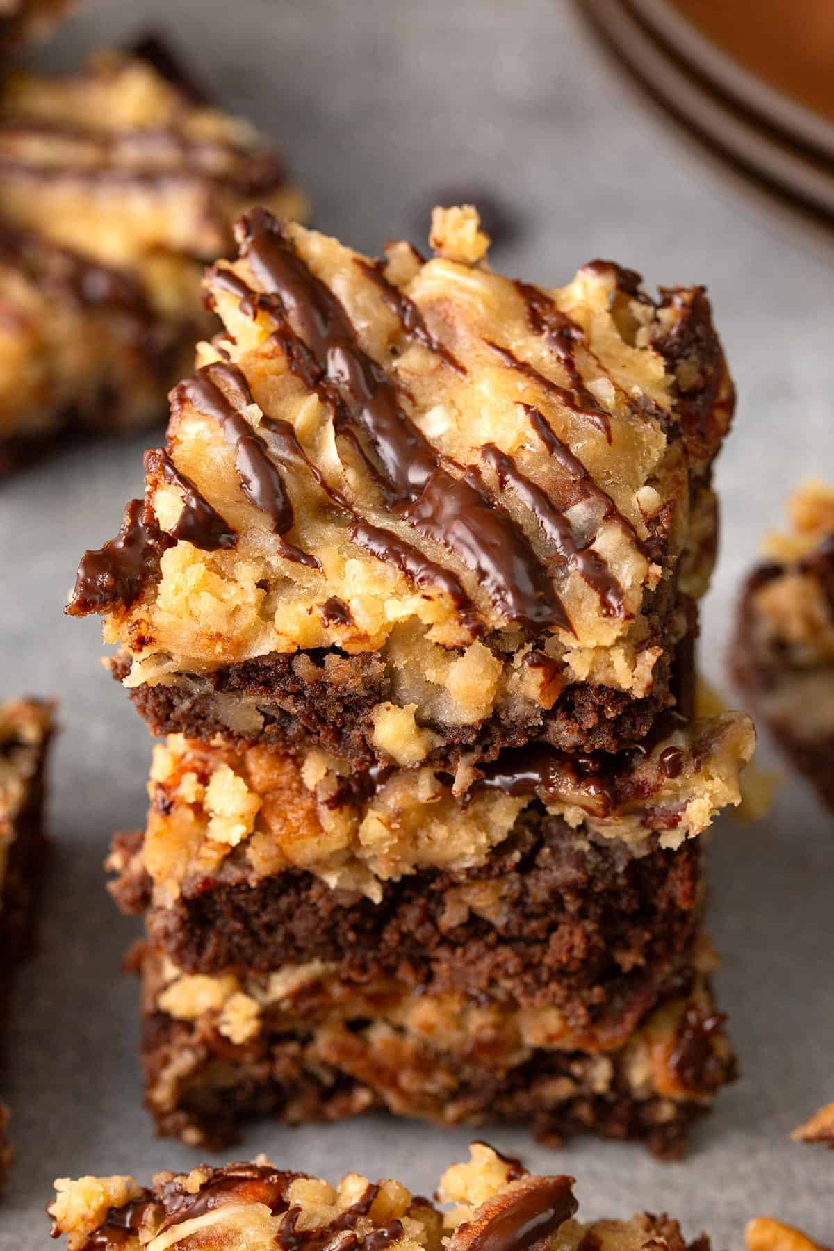 A stack of low carb German Chocolate Brownies on a concrete table.