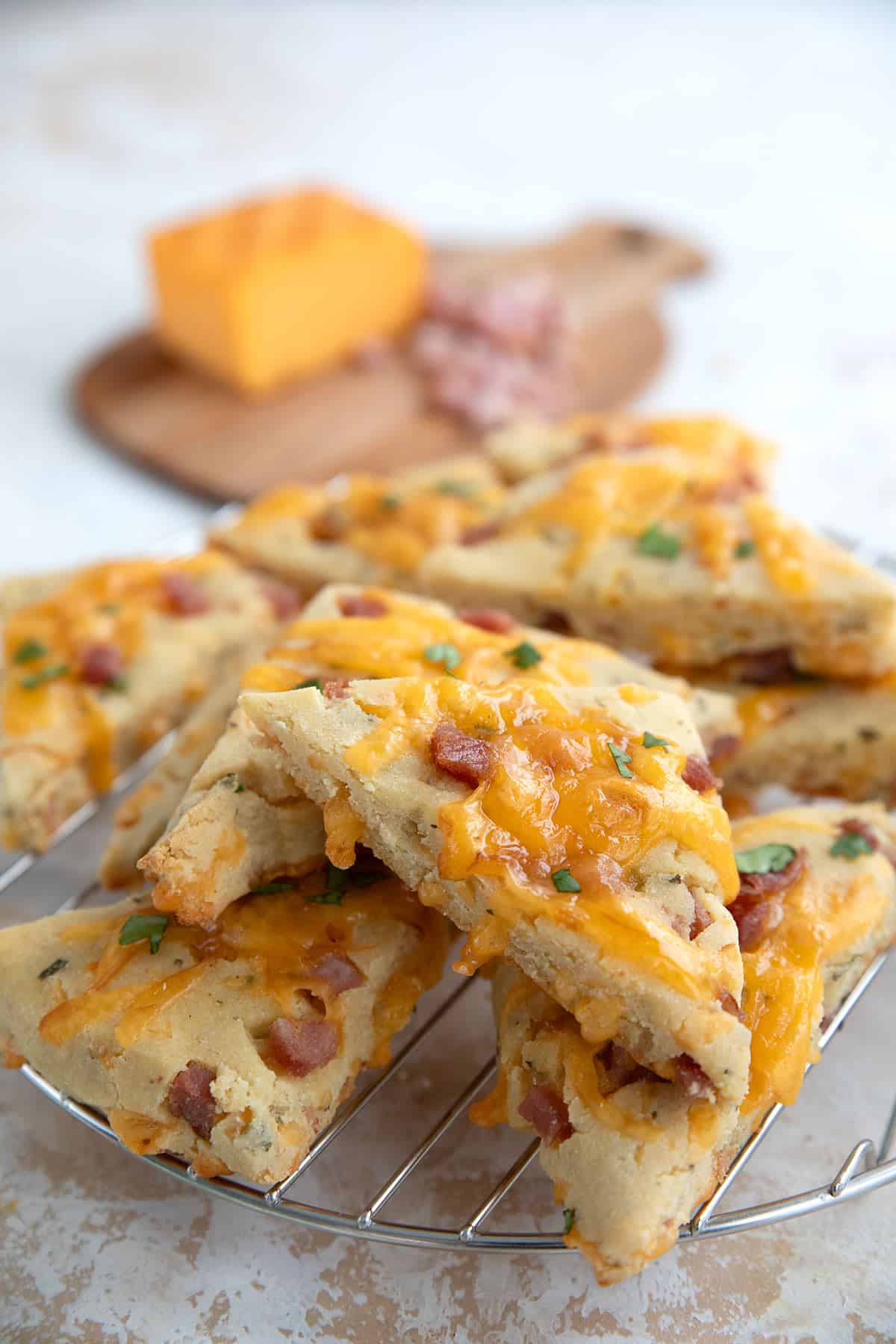 Ham and cheese scones arranged on a metal baking rack.