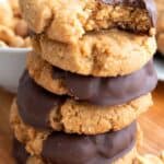 A stack of chocolate dipped keto peanut butter cookies with the title across the top.