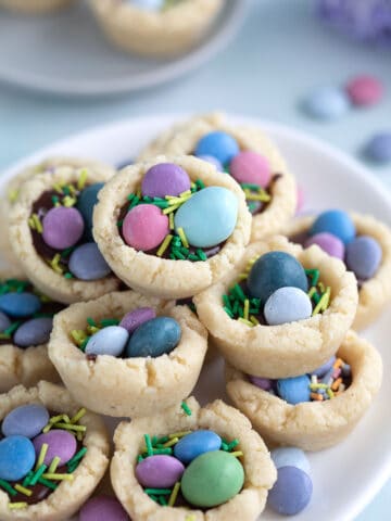 Close up shot of Easter Cookie Cup piled up on a white plate.