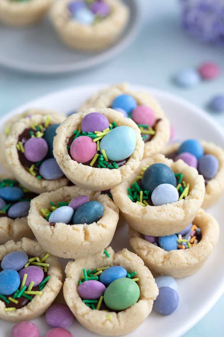 Close up shot of Easter Cookie Cup piled up on a white plate.