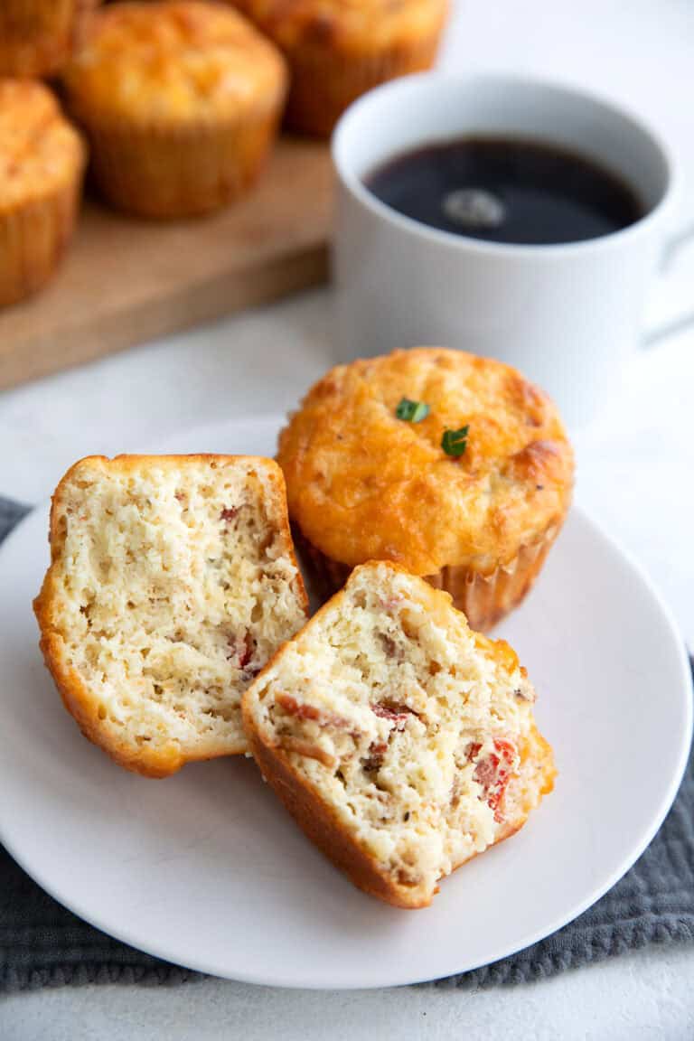 Keto Cottage Cheese Muffins with one broken open on a white plate.