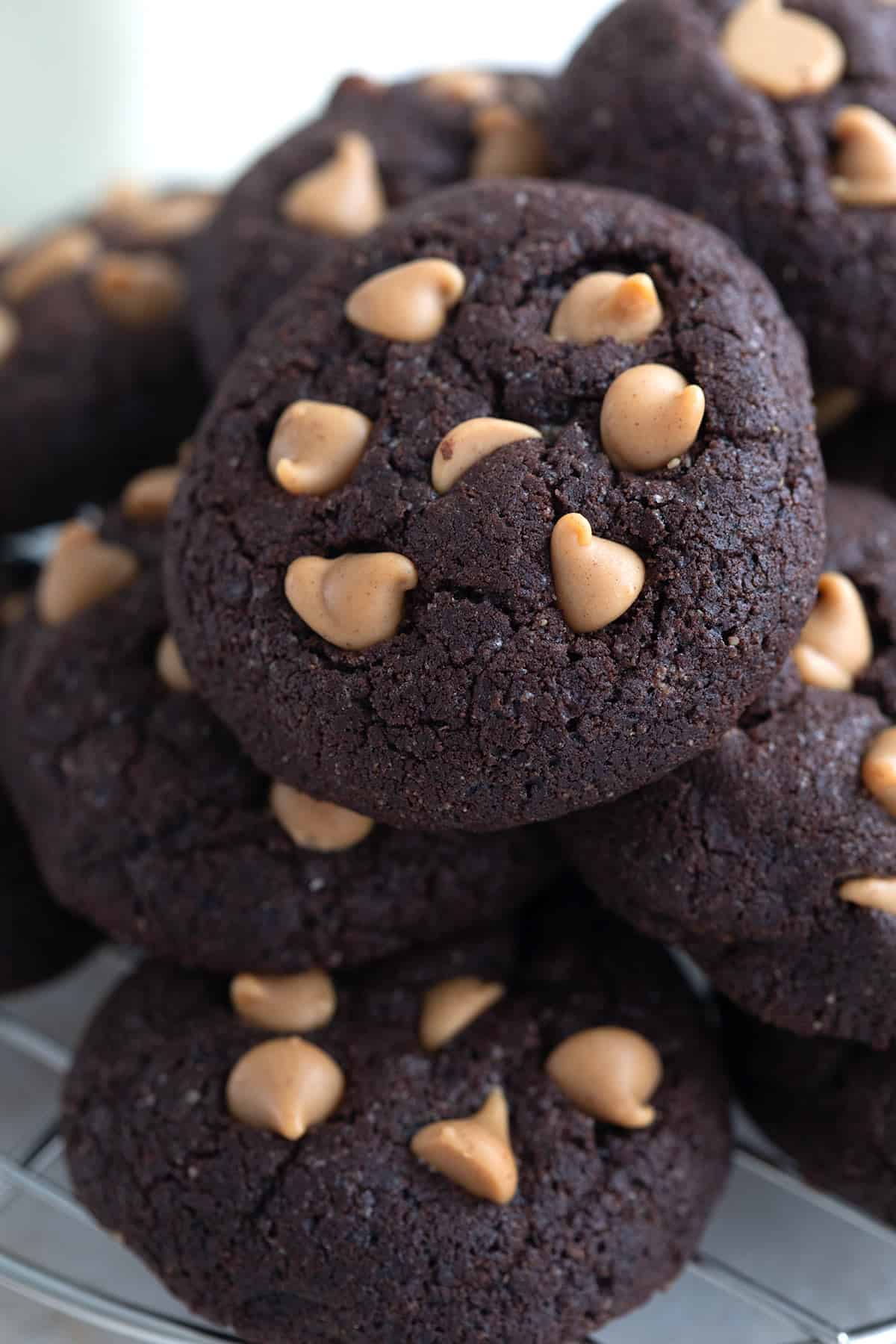 Close up shot of a pile of Keto Chocolate Cookies with Peanut Butter Chips.