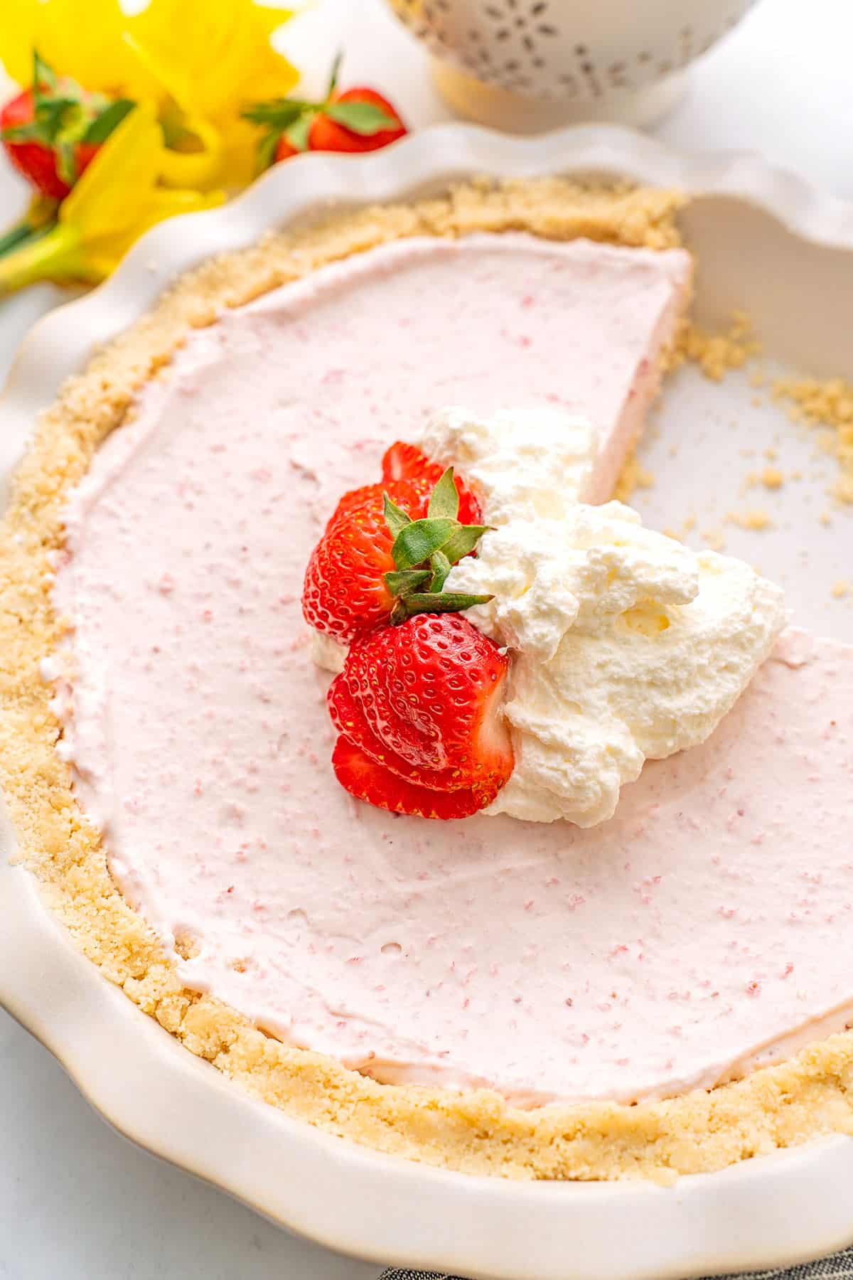 Top down image of Keto Strawberry Cream Pie with a slice cut out of it.