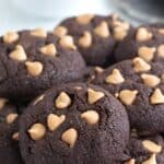 Keto Chocolate Peanut Butter Cookies piled up on a cooling rack.