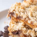 Close up shot of Sugar Free Keto Carmelitas on a white plate with chocolate chips strewn around.