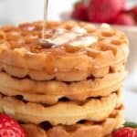 Titled image of a stack of keto waffles with syrup being poured over.