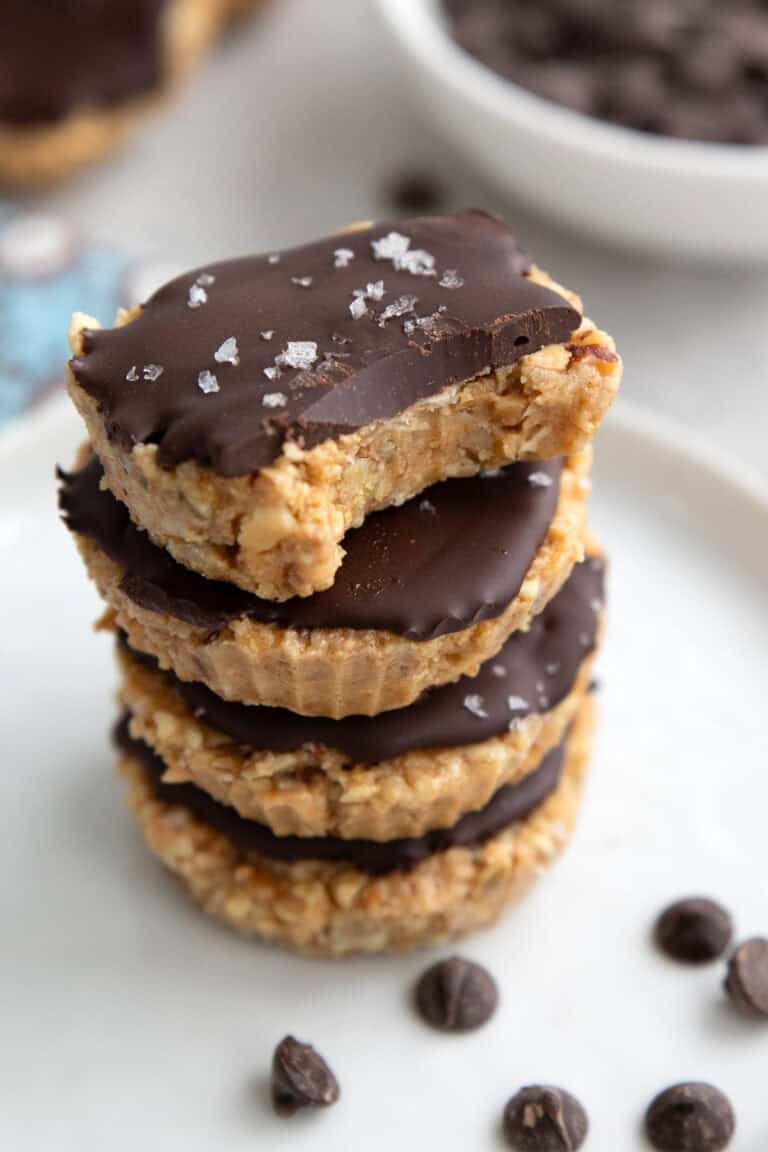 Close up shot of a stack of keto protein bites with a bite taken out of the top one.