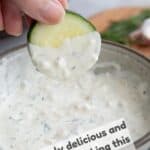 Titled image of creamy feta dressing, with a cucumber being dipped into it.